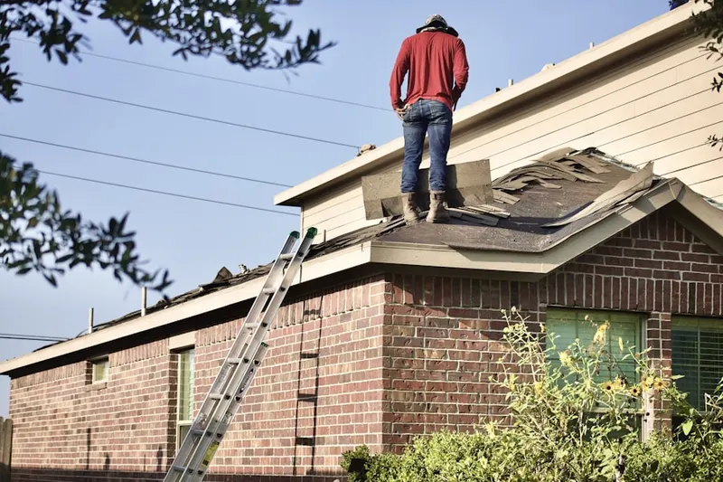 Professional roofer working on a residential roof in Pierson Place